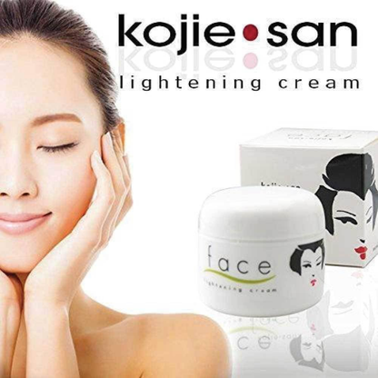 Kojie San lightening cream with a woman's face and product packaging on a white background